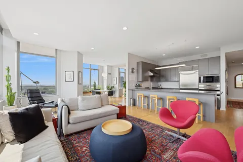 a living room with furniture kitchen and a table