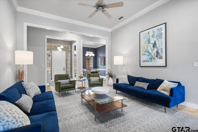 a living room with furniture and a large mirror