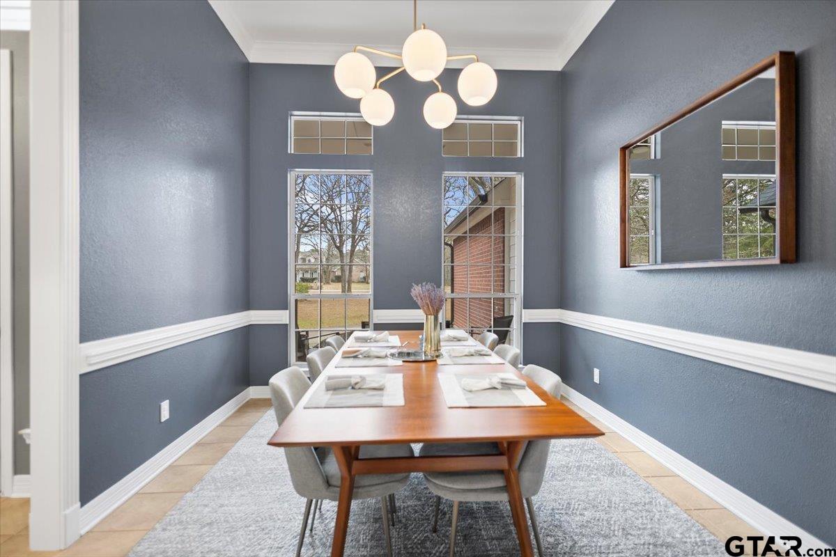 17679 Briarpatch Lindale, TX 75771 - Photo 12 of 47 a dining room with wooden floor a chandelier a wooden table and chairs