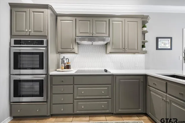 a kitchen with stainless steel appliances granite countertop a stove and a microwave