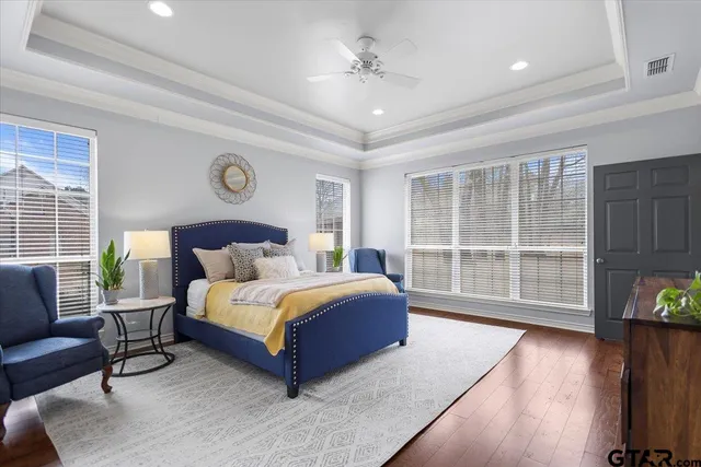 a spacious bedroom with a bed and glass door