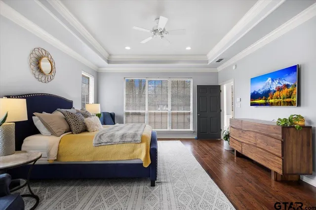 a bedroom with a bed window and a table