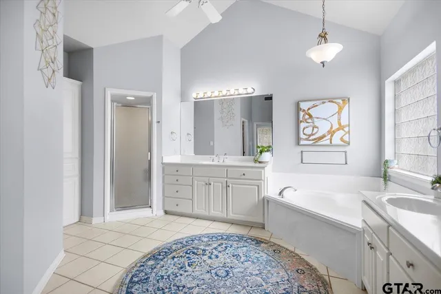 a spacious bathroom with a sink a large mirror and a bathtub