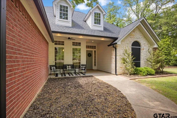 a spacious bedroom with a bed and glass door