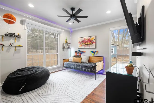 a bedroom with furniture and a large window