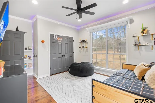 a bedroom with a bed and a large window