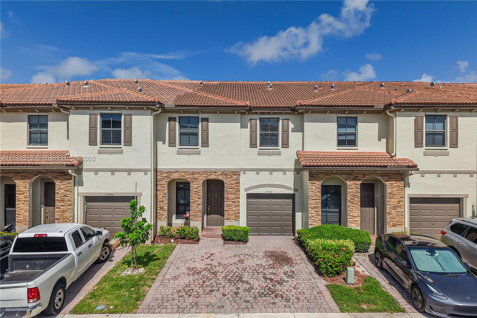 23634 Southwest 117 Place Homestead, FL 33032 - Photo 2 of 31 a front view of a house with garden