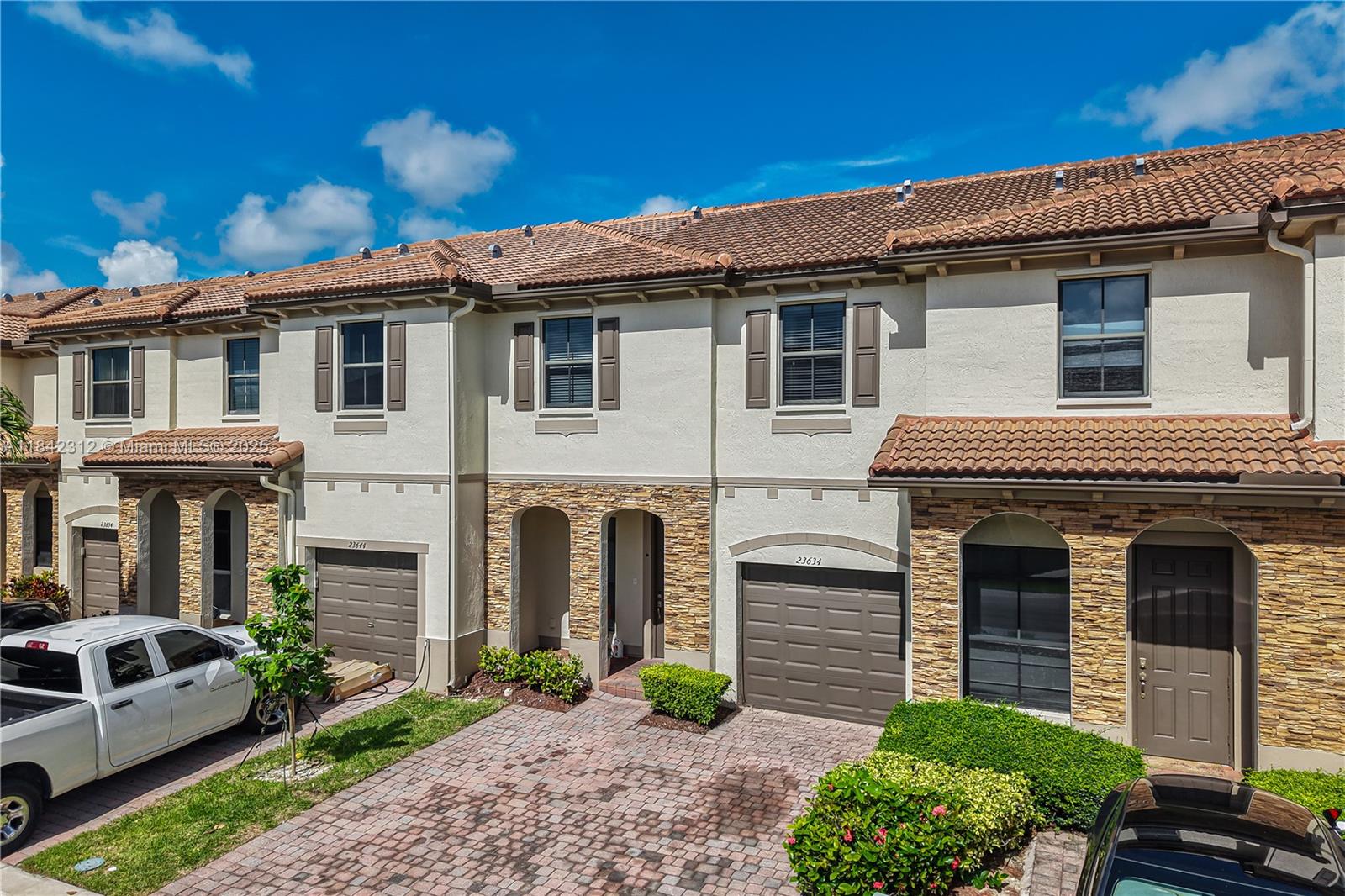 23634 Southwest 117 Place Homestead, FL 33032 - Photo 3 of 31 a front view of a house with garden