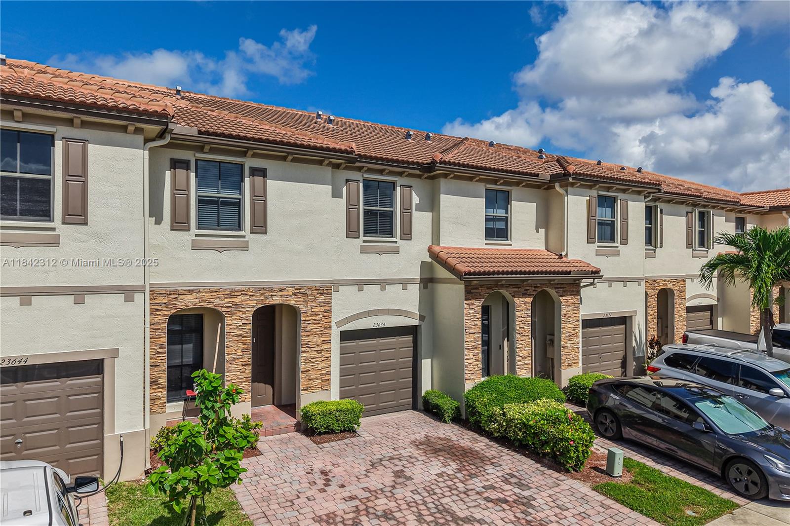 23634 Southwest 117 Place Homestead, FL 33032 - Photo 4 of 31 a front view of a house with garden
