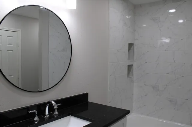 a bathroom with a mirror and a shower