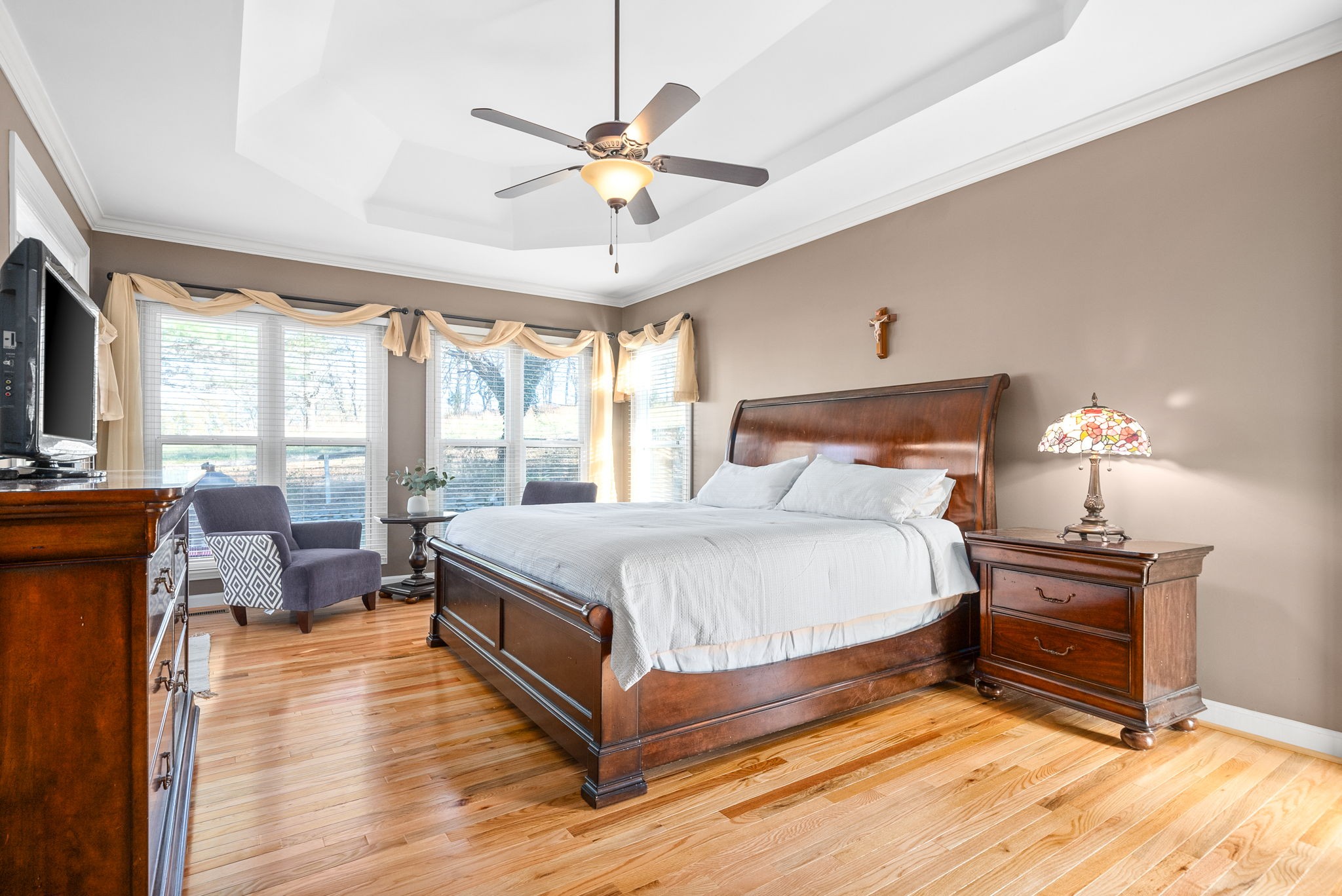 1904 Springcroft Drive Franklin, TN 37067 - Photo 15 of 30 a bedroom with a large bed a chandelier and windows