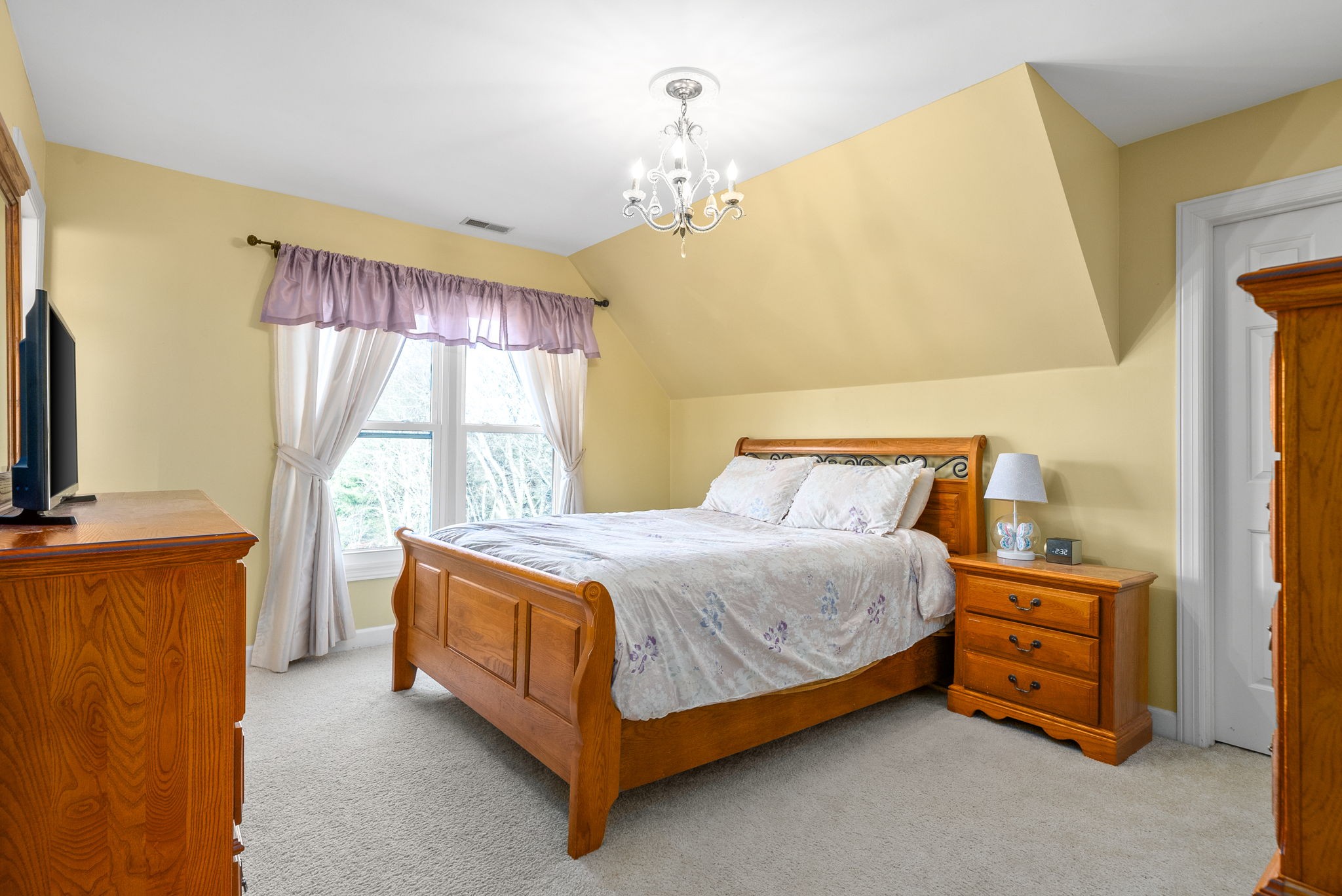 1904 Springcroft Drive Franklin, TN 37067 - Photo 18 of 30 a bedroom with a bed and a chandelier