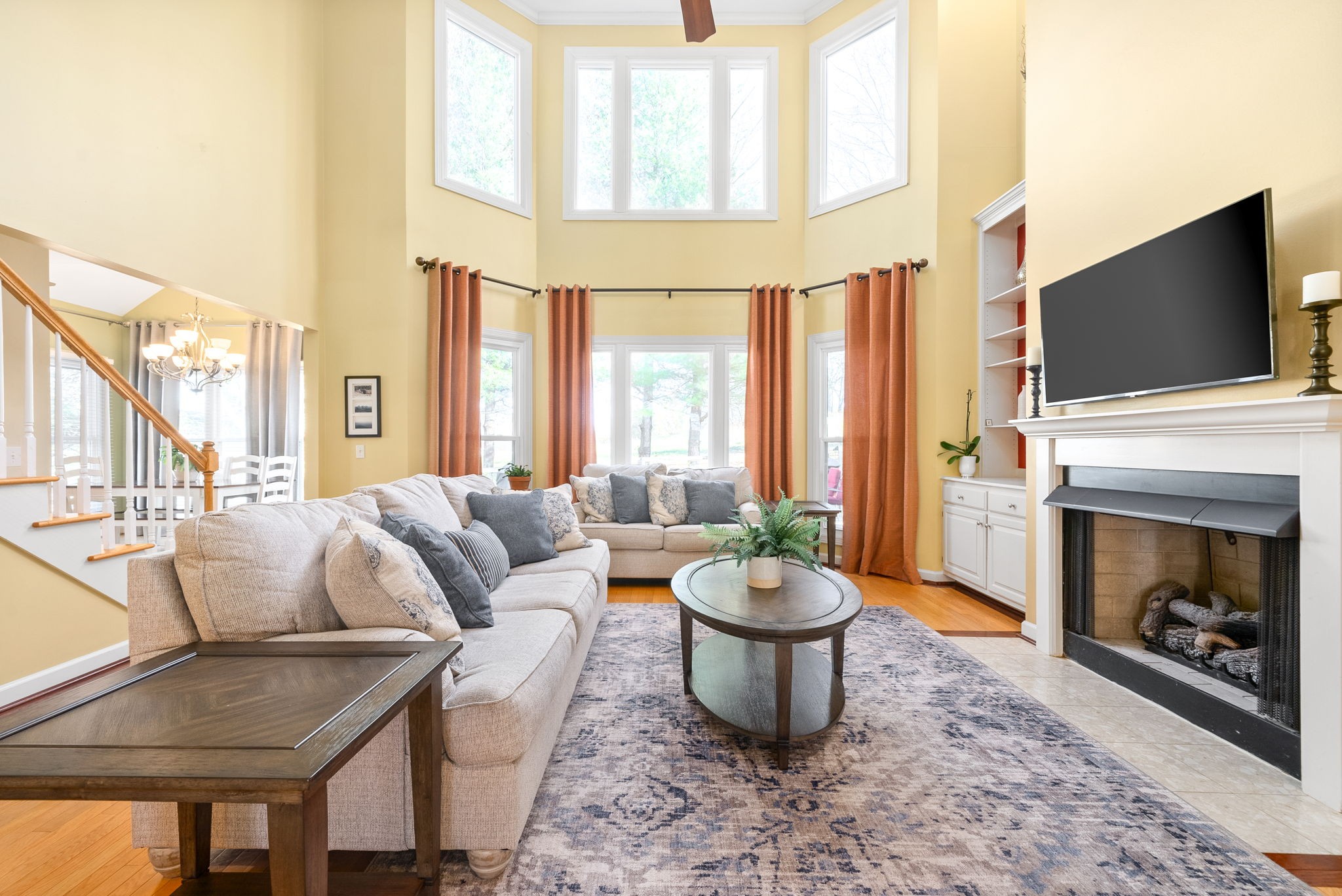 1904 Springcroft Drive Franklin, TN 37067 - Photo 6 of 30 a living room with furniture a flat screen tv and a fireplace