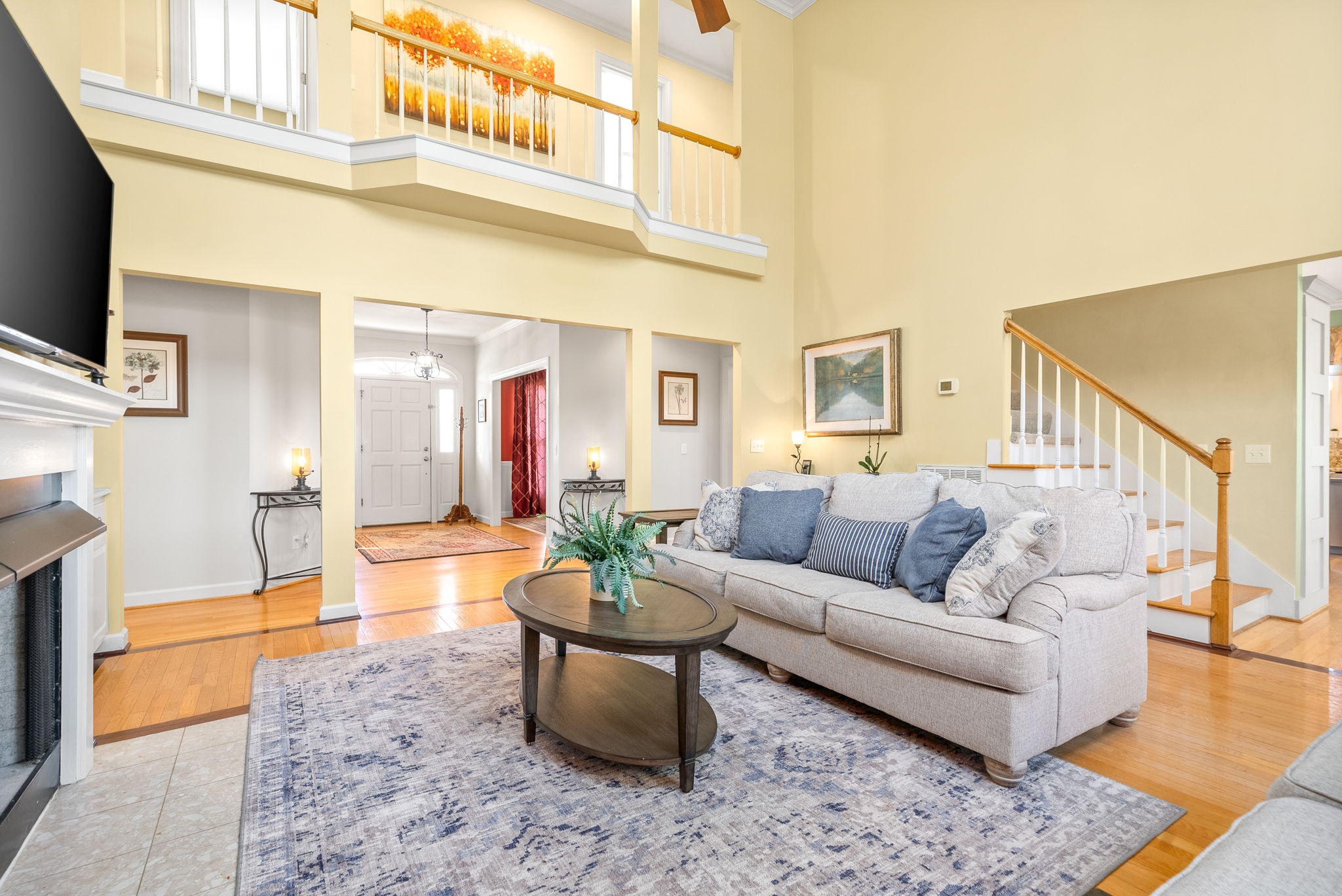 1904 Springcroft Drive Franklin, TN 37067 - Photo 7 of 30 a living room with furniture a flat screen tv and a table