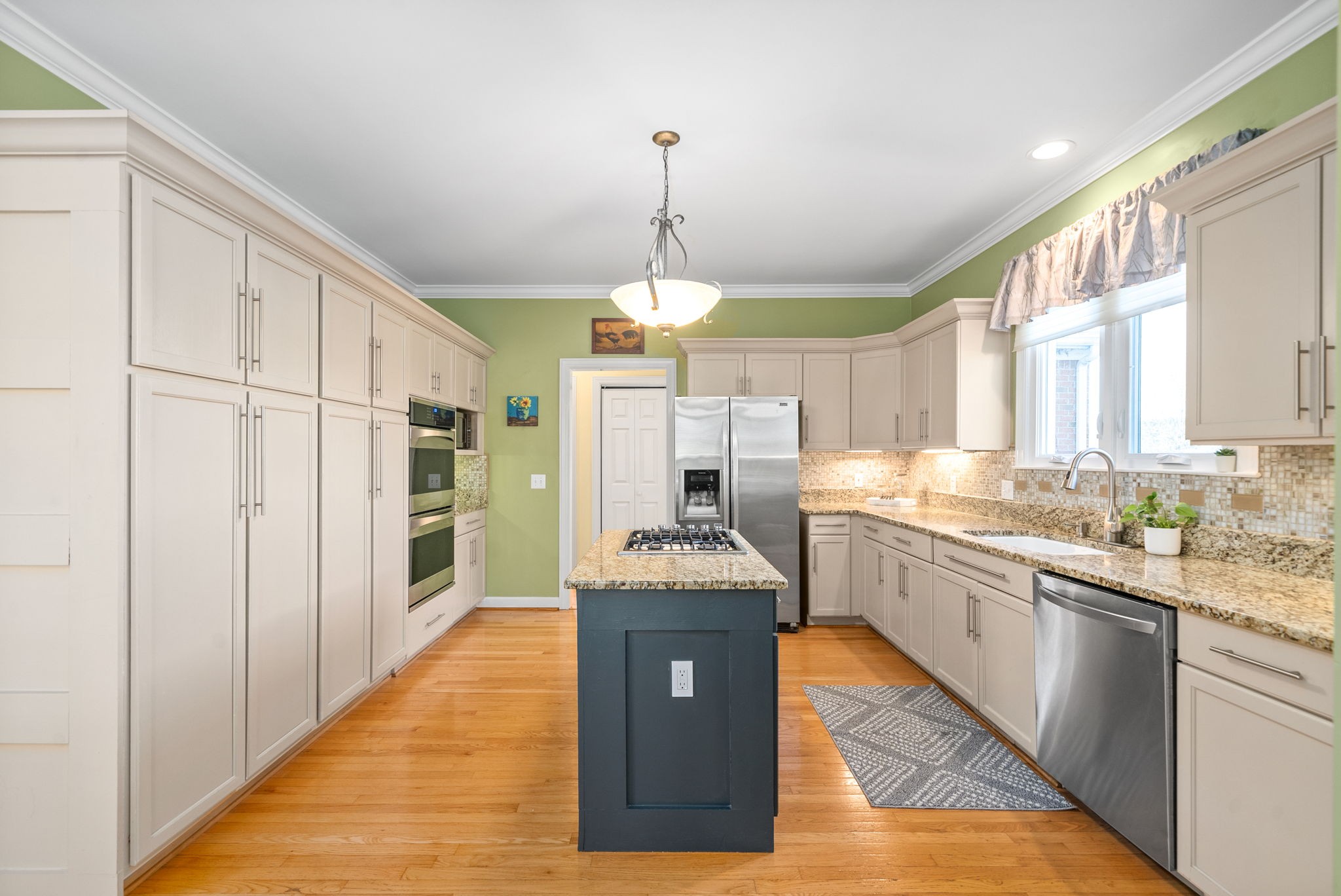 1904 Springcroft Drive Franklin, TN 37067 - Photo 9 of 30 a kitchen with stainless steel appliances granite countertop a stove refrigerator and cabinets