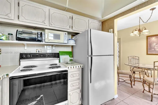 a kitchen with stainless steel appliances a refrigerator a stove a sink and cabinets