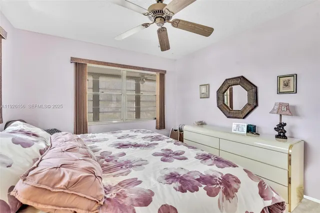 a bedroom with a bed and a mirror on the dresser