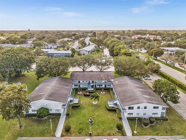 an aerial view of residential houses with outdoor space and river