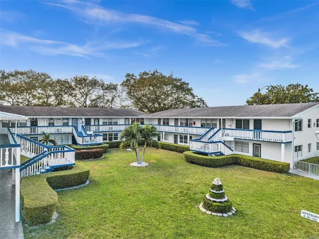 a view of a house with swimming pool and yard