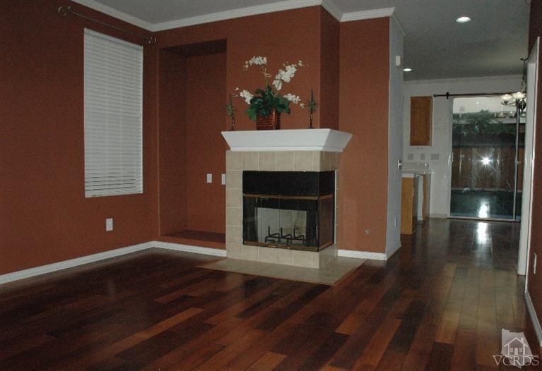 802 Pivot Point Way Oxnard, CA 93035 - Photo 2 of 13 a living room with wooden floor and a fireplace