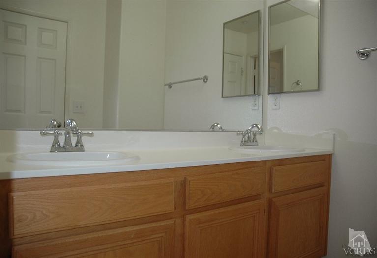 802 Pivot Point Way Oxnard, CA 93035 - Photo 13 of 13 a bathroom with a sink and a mirror