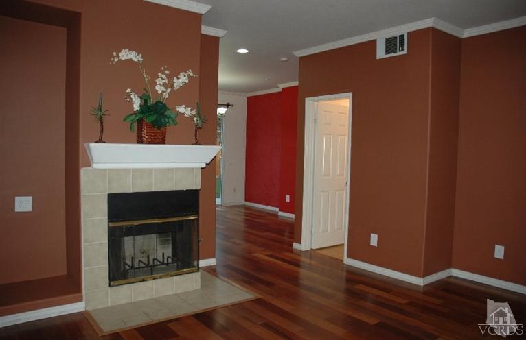 802 Pivot Point Way Oxnard, CA 93035 - Photo 3 of 13 a view of an empty room with wooden floor and a fireplace