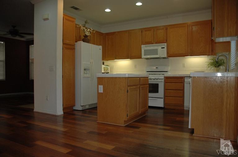 802 Pivot Point Way Oxnard, CA 93035 - Photo 4 of 13 a kitchen with stainless steel appliances granite countertop a refrigerator a sink and a stove