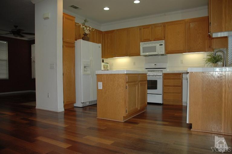 802 Pivot Point Way Oxnard, CA 93035 - Photo 7 of 13 a kitchen with stainless steel appliances a refrigerator and a stove top oven