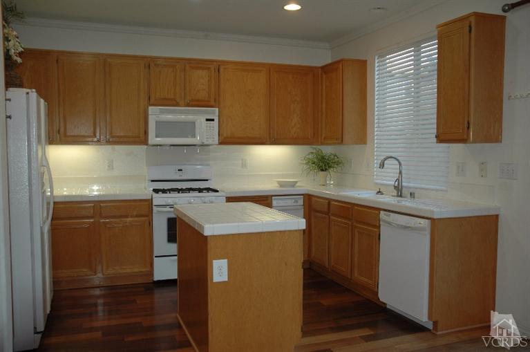 802 Pivot Point Way Oxnard, CA 93035 - Photo 8 of 13 a kitchen with stainless steel appliances granite countertop a sink stove and refrigerator
