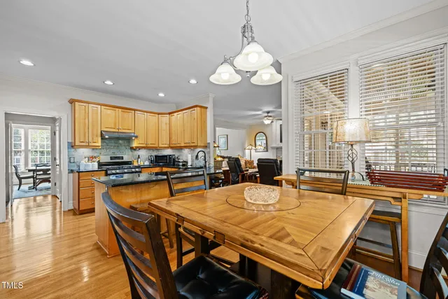 a dining table with chairs and wooden floor