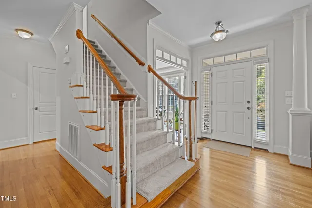 a view of entryway and hall with wooden floor