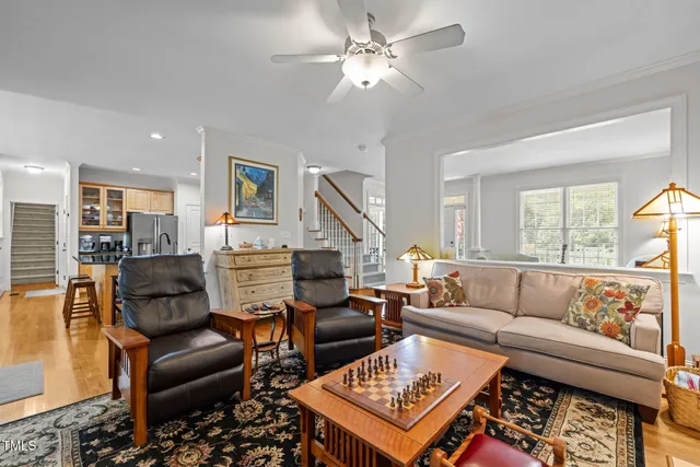 a living room with furniture ceiling fan and a rug