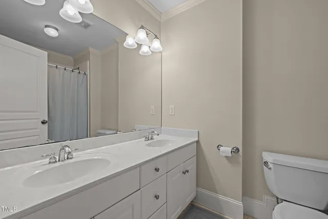 a bathroom with a toilet a sink and shower