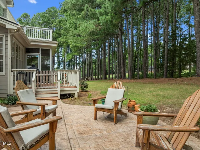 an aerial view of residential houses with outdoor space and trees