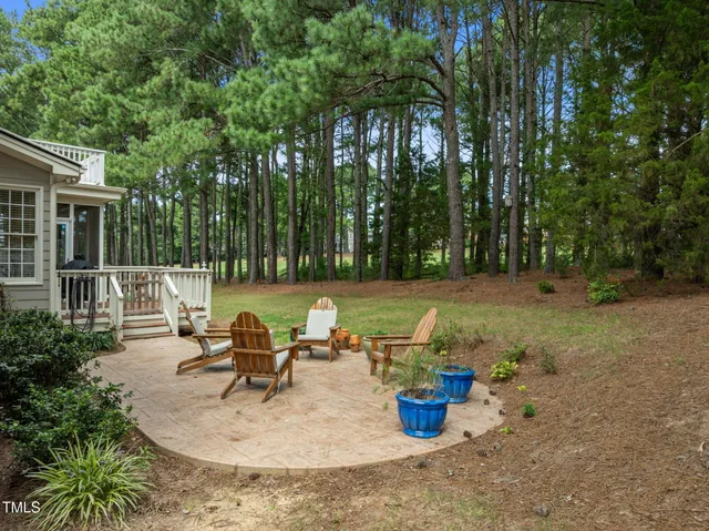an aerial view of residential houses with outdoor space and trees