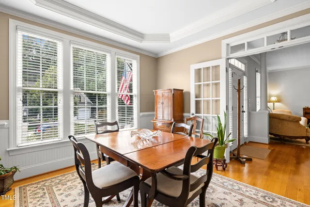 a dining room with furniture and a floor to ceiling window