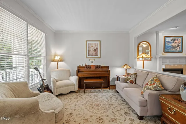 a living room with furniture ceiling fan and a window