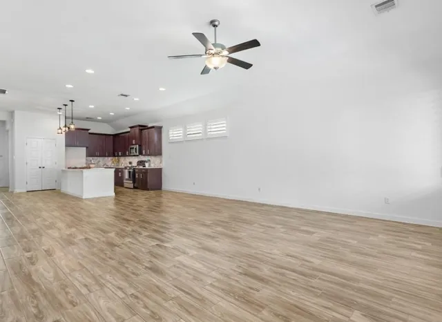 a view of kitchen and kitchen with stainless steel appliances