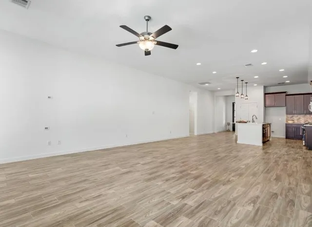 a view of a kitchen with a sink and a refrigerator