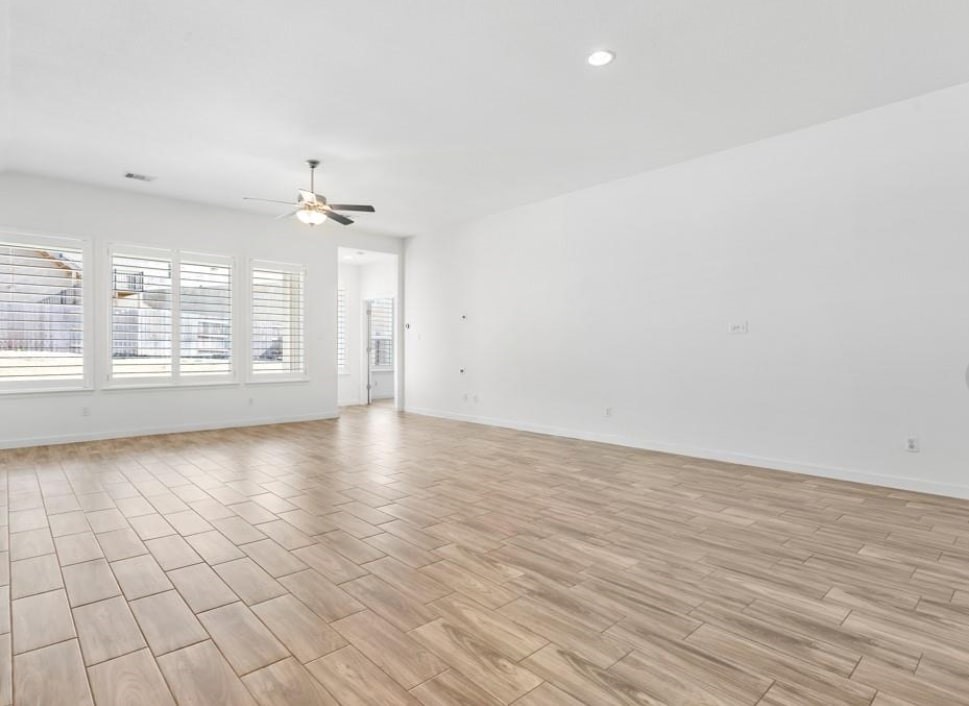 121 San Domenico Cove Georgetown, TX 78628 - Photo 13 of 24 an empty room with wooden floor and windows