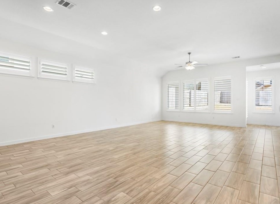 121 San Domenico Cove Georgetown, TX 78628 - Photo 14 of 24 wooden floor in an empty room with a window