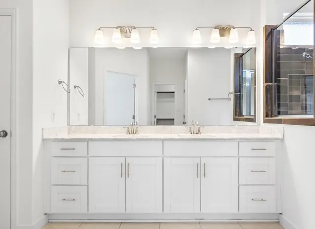 a bathroom with a sink vanity and mirror