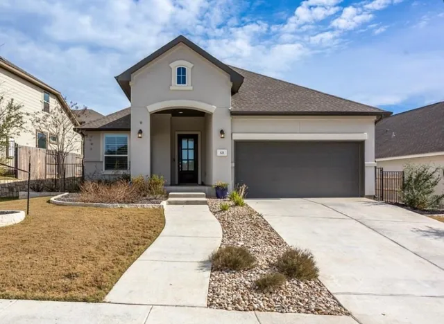 a front view of a house with yard