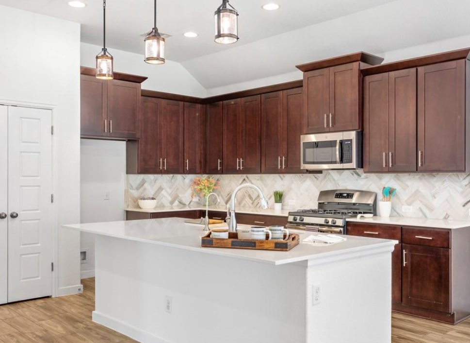 121 San Domenico Cove Georgetown, TX 78628 - Photo 6 of 24 a kitchen with stainless steel appliances granite countertop a sink a stove and a refrigerator