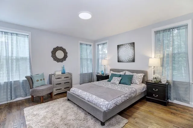 a bedroom with a bed a couch and dresser