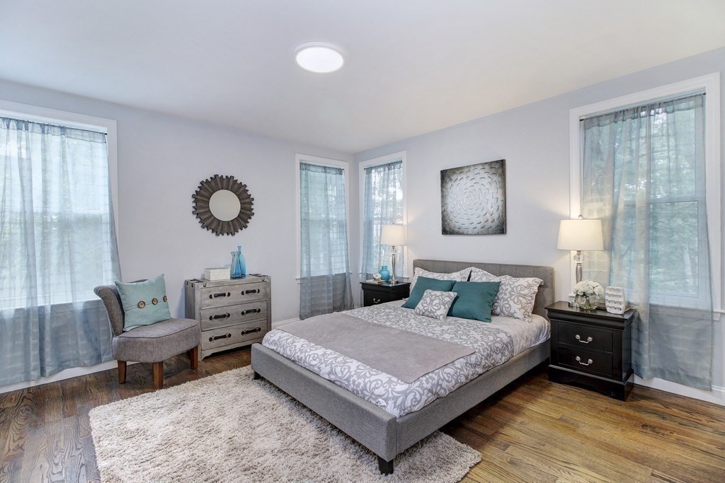 757 Washington Street, Unit 1 Boston, MA 02124 - Photo 11 of 17 a bedroom with a bed a couch and dresser