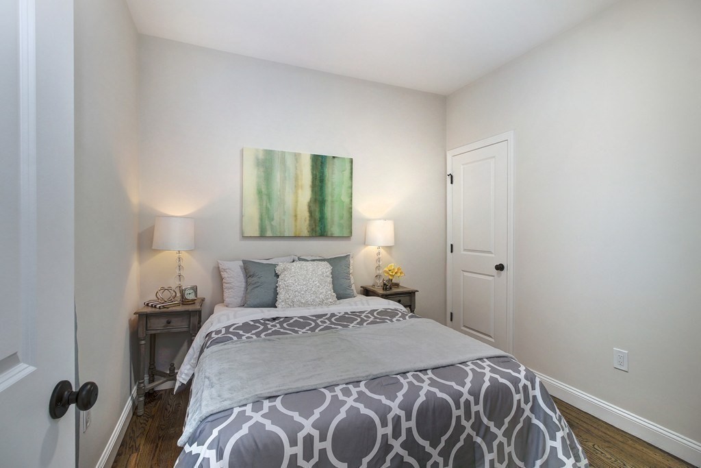 757 Washington Street, Unit 1 Boston, MA 02124 - Photo 12 of 17 a bedroom with a bed and a lamp