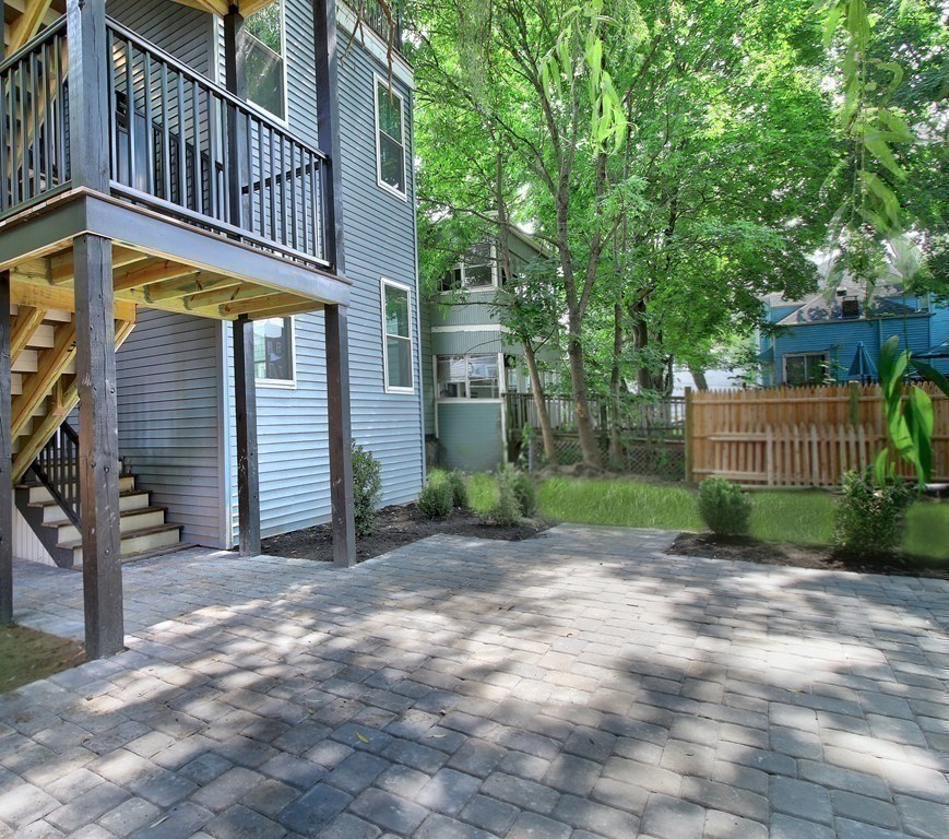 757 Washington Street, Unit 1 Boston, MA 02124 - Photo 17 of 17 a view of a house with large windows and a small yard