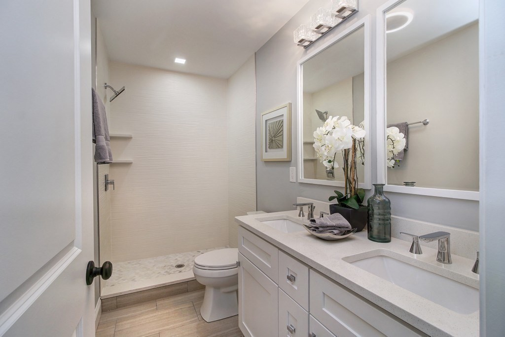 757 Washington Street, Unit 1 Boston, MA 02124 - Photo 8 of 17 a bathroom with a granite countertop sink toilet and shower