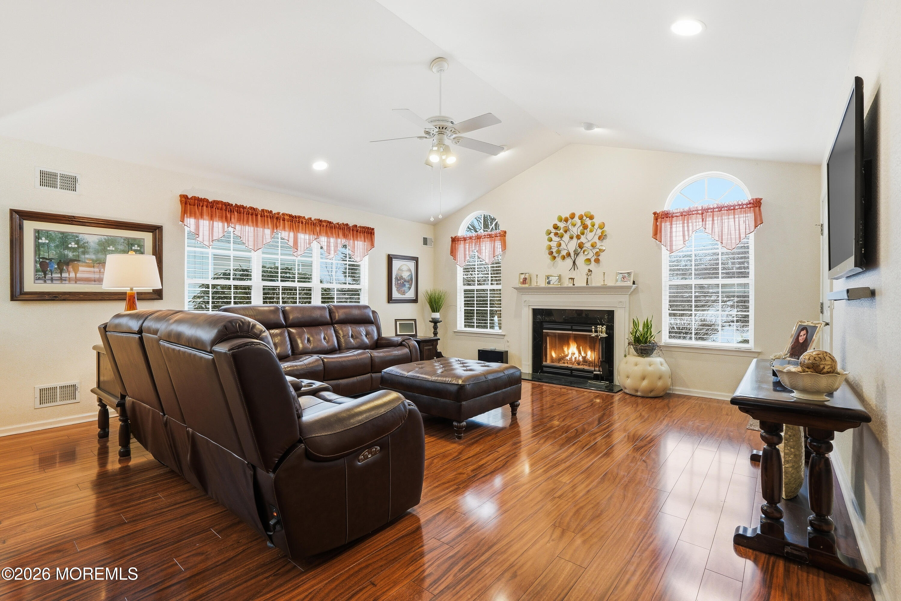 8 Casco Court Lakewood, NJ 08701 - Photo 18 of 56 a living room with furniture a fireplace and a flat screen tv